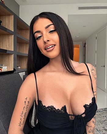 Malu Trevejo Stuns in Black: Flirty Cleavage & Panty Peek